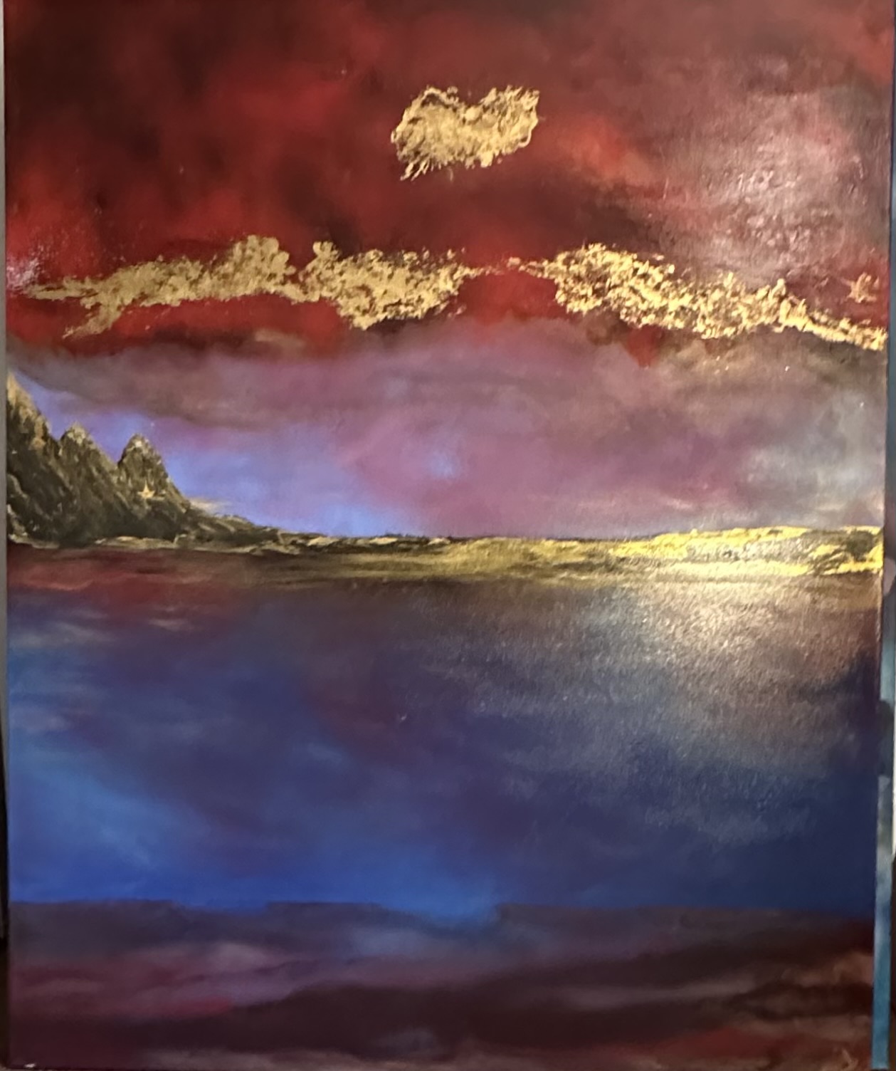 A deep blue landscape beneath a red sky and luminous gold forms.