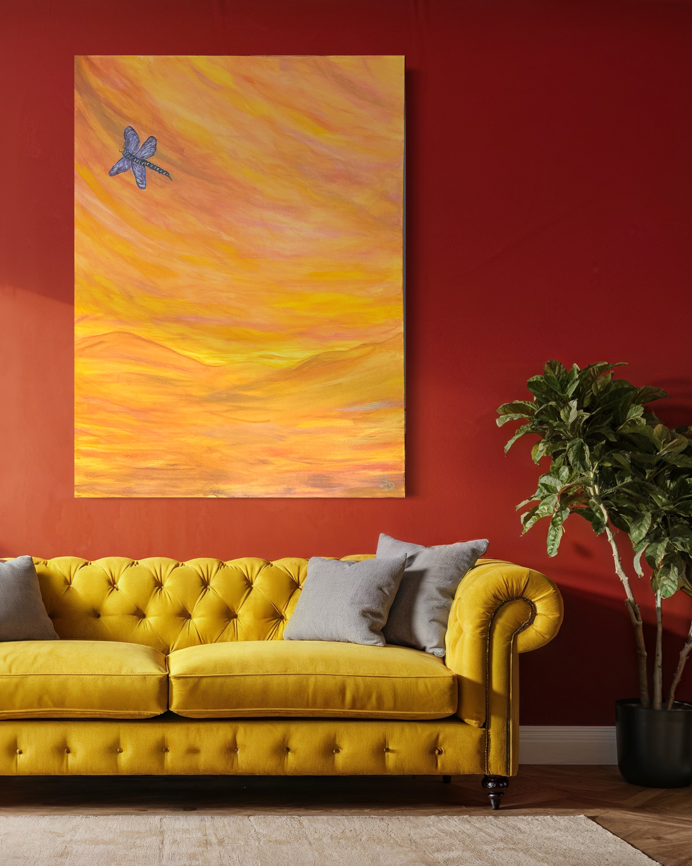 A yellow butterfly work presented above a yellow sofa against a red wall.
