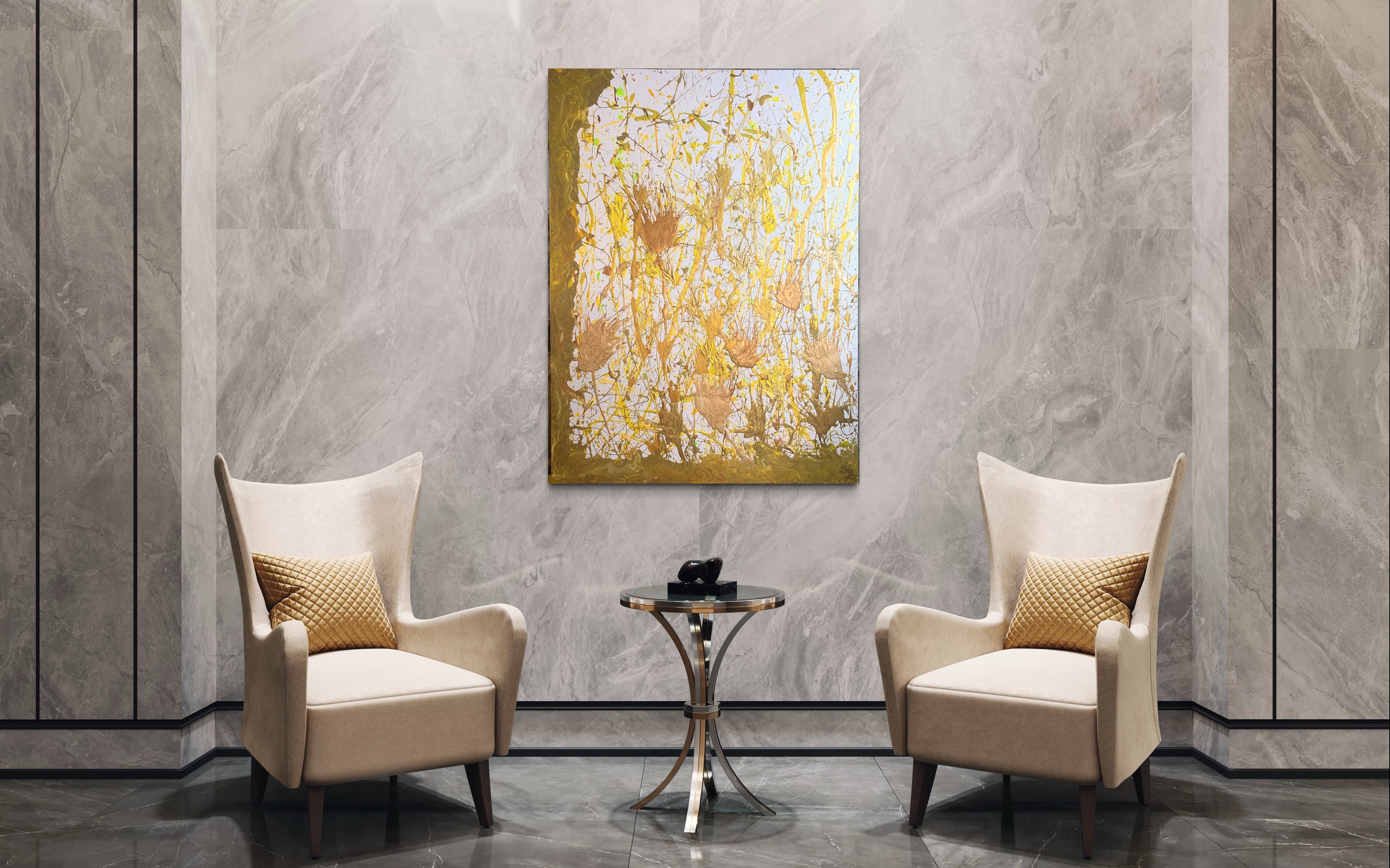 A gold and white vertical work presented between two lounge chairs.